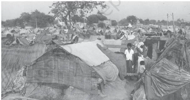 Development Policies and Experience (1947-90) Class 11 People in colonial India living without basic housing, showing the poverty described in the chapter on the Indian economy on the eve of independence