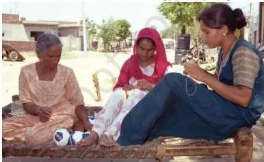 Women at home in Ludhiana stitching footballs for large MNCs, showing small home-based producers inside a global production chain
