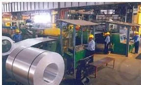 Industrial photograph of a strip mill at the NALCO aluminium smelter, where aluminium metal is rolled into strips for further processing