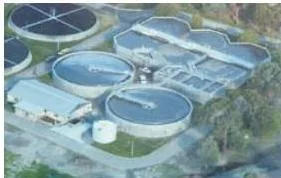 Microbes in Human Welfare Class 12 Aerial view of a sewage treatment plant showing its many tanks, illustrating the scale at which microbes purify waste water daily
