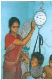 A bottle of iron and folic acid drops being given to a child, showing the nutrient-based supplementation approach to preventing anaemia