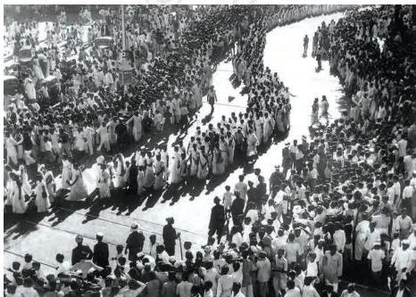 A procession of women marching through Bombay streets during the Quit India Movement, many carrying Congress flags