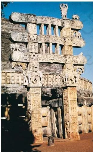 Thinkers, Beliefs and Buildings Class 12 PDF (Theme 4) The eastern gateway of the Sanchi stupa, its pillars and crossbars densely covered with carved panels and figures
