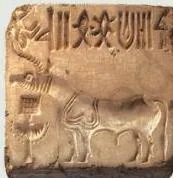 A square steatite seal with an animal motif and a line of undeciphered Harappan script, the signature artefact of the civilisation