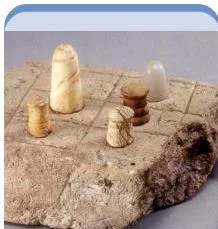 Small polished stone cones, captioned Gamesmen or lingas — even the excavator Mackay was unsure whether they were religious symbols or board-game pieces